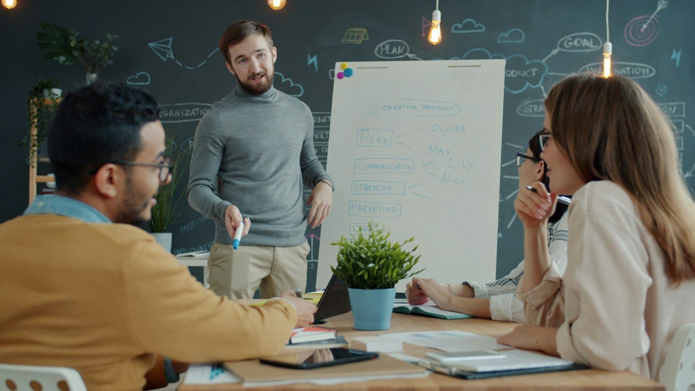 Founders planning strategy on a whiteboard